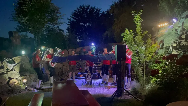 Abendauftritt der WindBradler bei Bühnenlicht im Garten